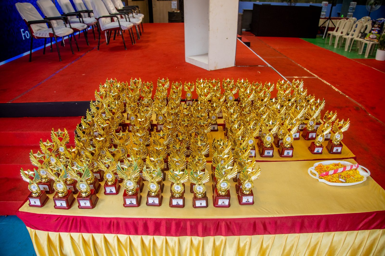 Large display of event trophies ready for presentation
